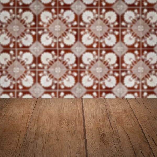 Wood table top and blur vintage ceramic tile pattern wall — Stock Photo, Image