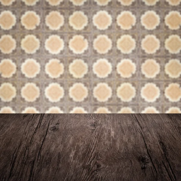 Wood table top and blur vintage ceramic tile pattern wall — Stock Photo, Image