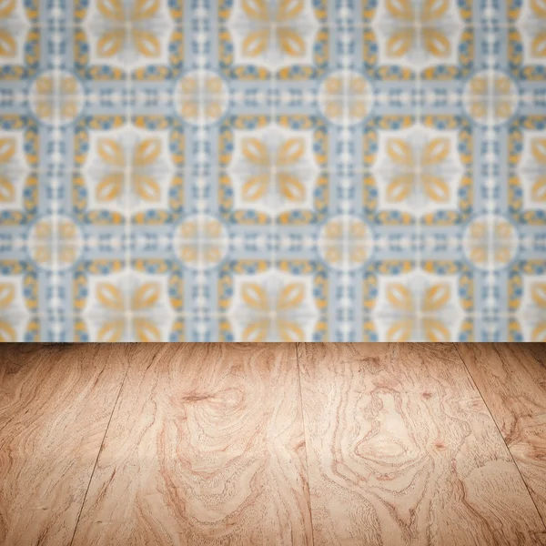 Wood table top and blur vintage ceramic tile pattern wall — Stock Photo, Image