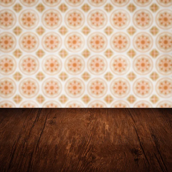 Wood table top and blur vintage ceramic tile pattern wall — Stock Photo, Image