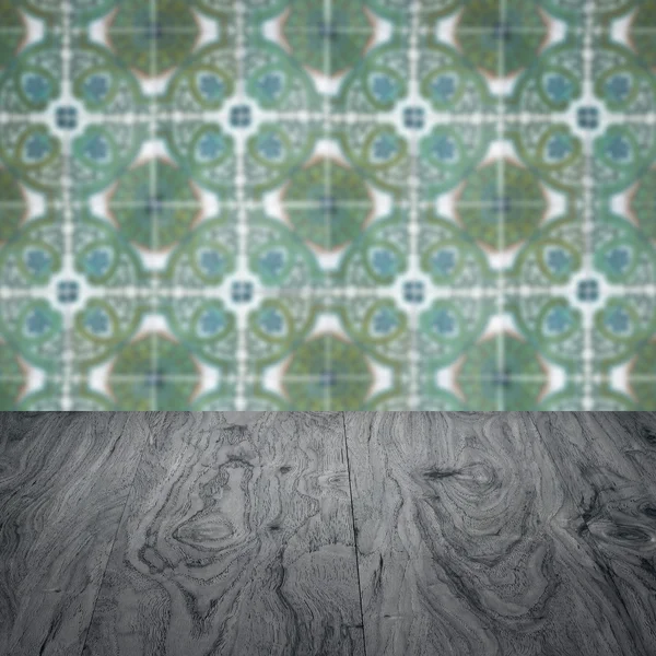 Wood table top and blur vintage ceramic tile pattern wall — Stock Photo, Image