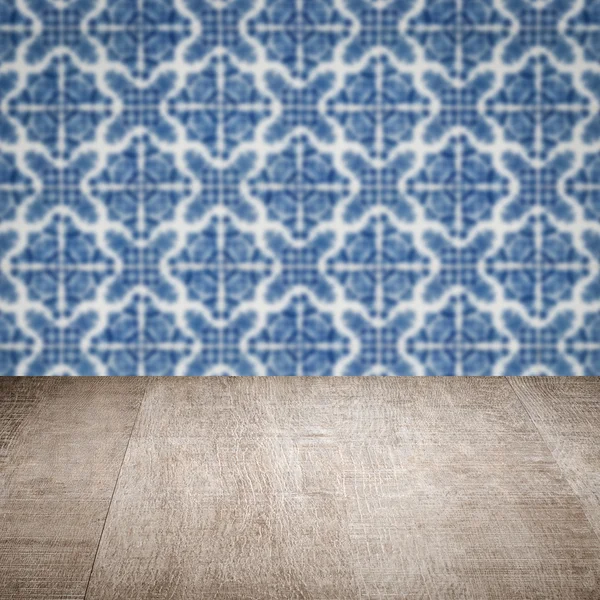 Wood table top and blur vintage ceramic tile pattern wall — Stock Photo, Image