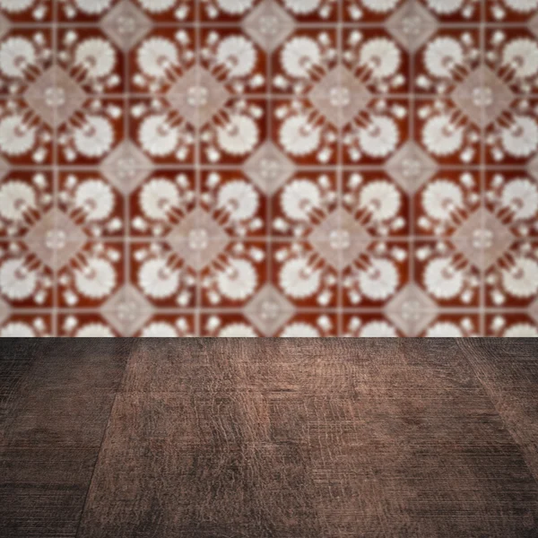 Wood table top and blur vintage ceramic tile pattern wall — Stock Photo, Image