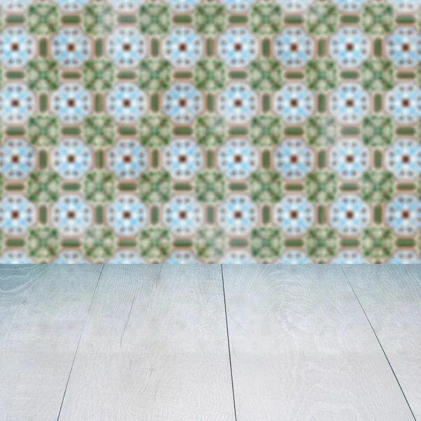 Wood table top and blur vintage ceramic tile pattern wall — Stock Photo, Image