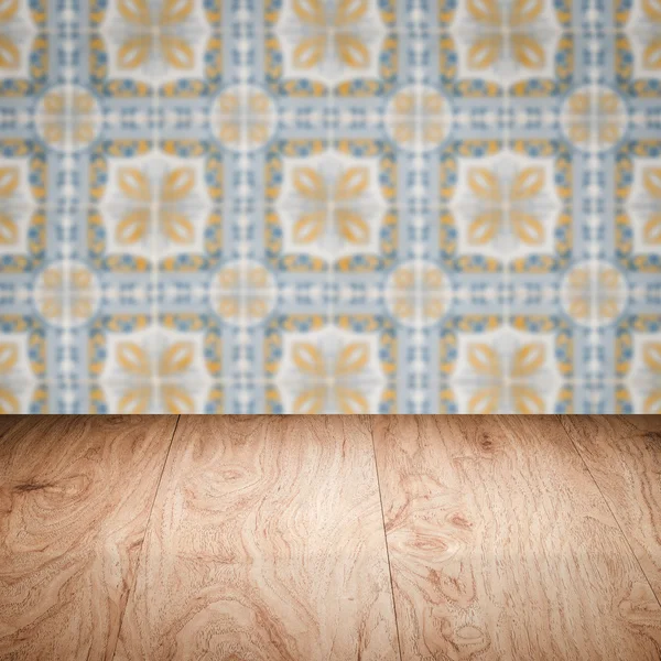 Wood table top and blur vintage ceramic tile pattern wall — Stock Photo, Image