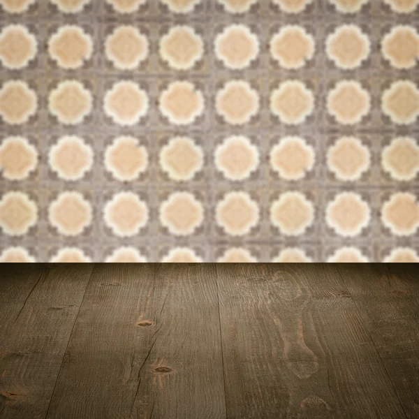 Wood table top and blur vintage ceramic tile pattern wall — Stock Photo, Image