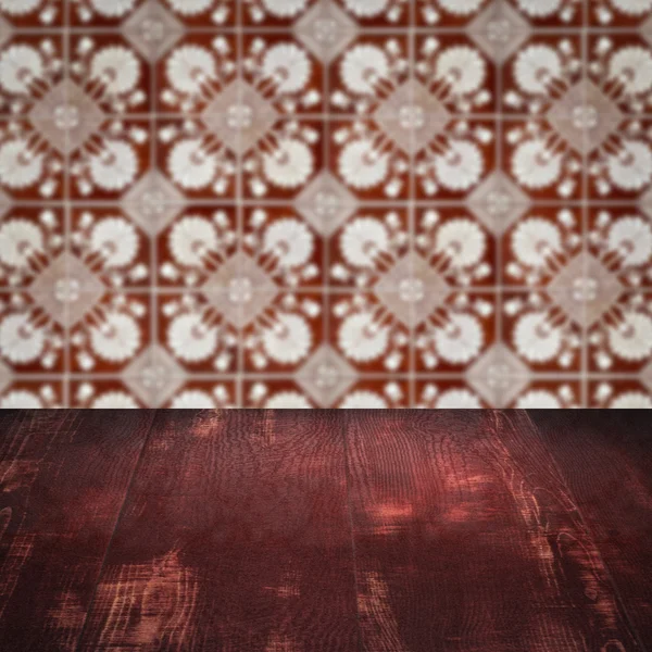 Wood table top and blur vintage ceramic tile pattern wall — Stock Photo, Image