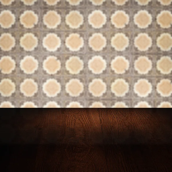 Wood table top and blur vintage ceramic tile pattern wall — Stock Photo, Image