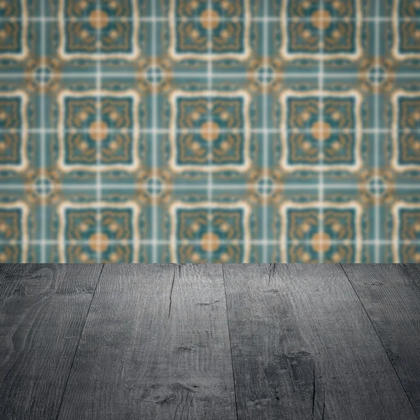 Wood table top and blur vintage ceramic tile pattern wall — Stock Photo, Image