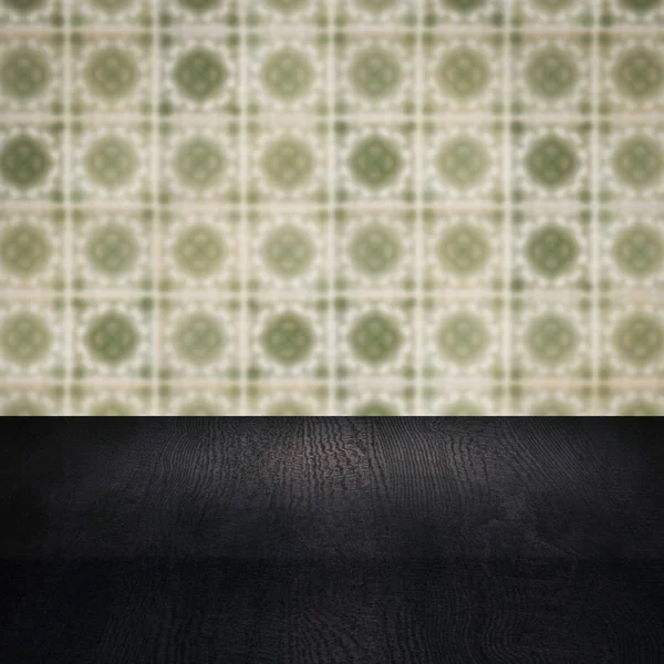 Wood table top and blur vintage ceramic tile pattern wall — Stock Photo, Image