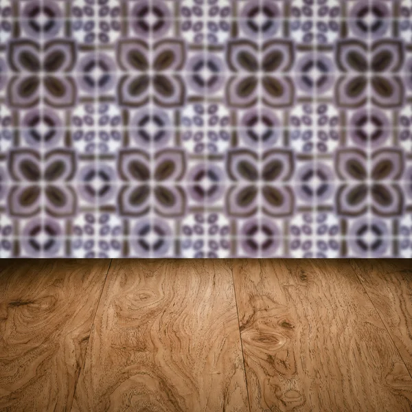 Wood table top and blur vintage ceramic tile pattern wall — Stock Photo, Image