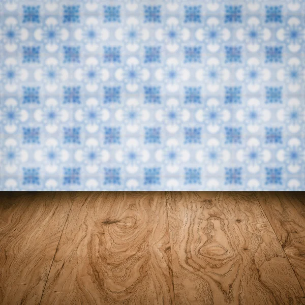 Wood table top and blur vintage ceramic tile pattern wall — Stock Photo, Image