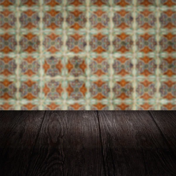 Wood table top and blur vintage ceramic tile pattern wall Royalty Free Stock Photos