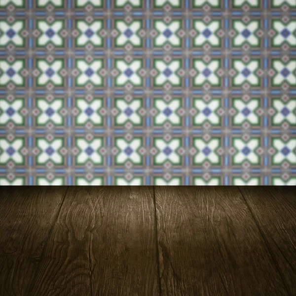 Wood table top and blur vintage ceramic tile pattern wall — Stock Photo, Image