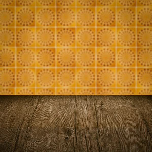 Wood table top and blur vintage ceramic tile pattern wall — Stock Photo, Image