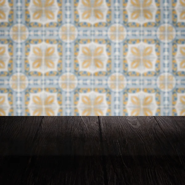 Wood table top and blur vintage ceramic tile pattern wall — Stock Photo, Image