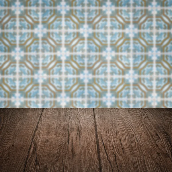 Wood table top and blur vintage ceramic tile pattern wall — Stock Photo, Image