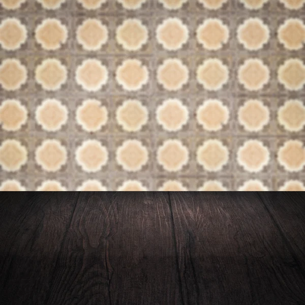 Wood table top and blur vintage ceramic tile pattern wall — Stock Photo, Image