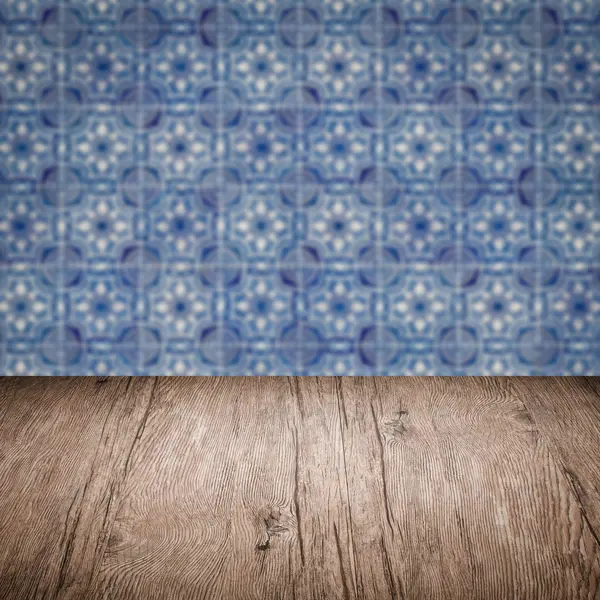 Wood table top and blur vintage ceramic tile pattern wall — Stock Photo, Image