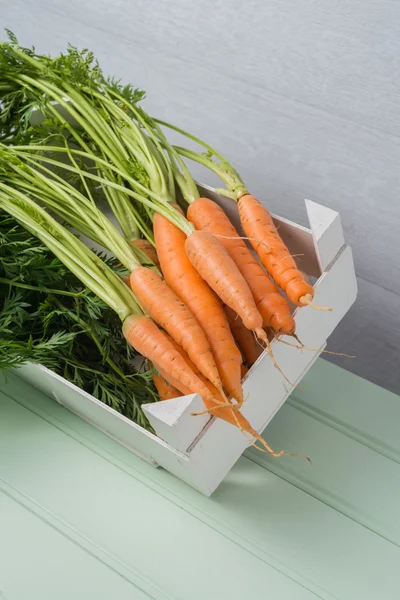 Carrots on wooden table — Stock Photo, Image