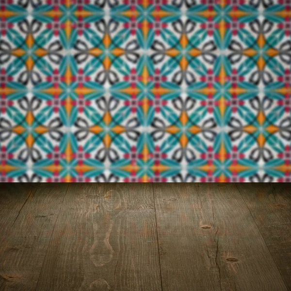 Wood table top and blur vintage ceramic tile pattern wall — Stock Photo, Image