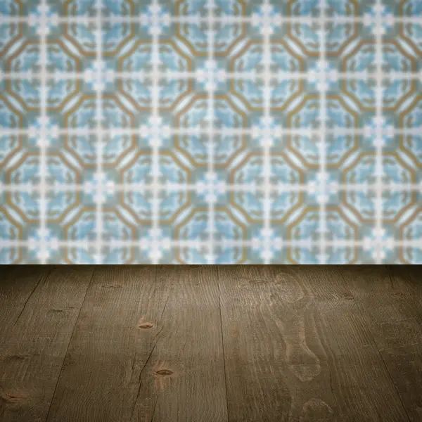 Wood table top and blur vintage ceramic tile pattern wall — Stock Photo, Image