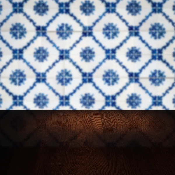 Wood table top and blur vintage ceramic tile pattern wall — Stock Photo, Image