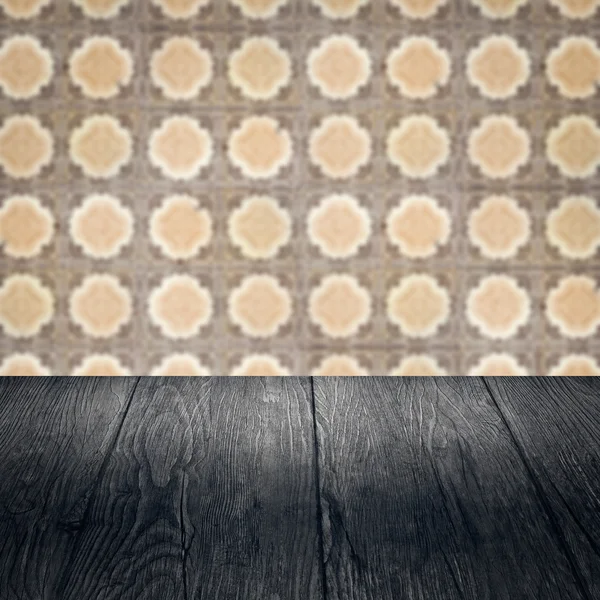 Wood table top and blur vintage ceramic tile pattern wall — Stock Photo, Image