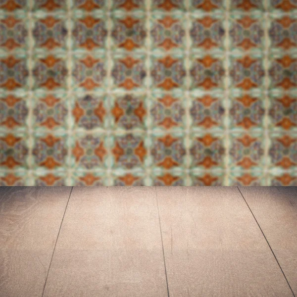 Wood table top and blur vintage ceramic tile pattern wall — Stock Photo, Image