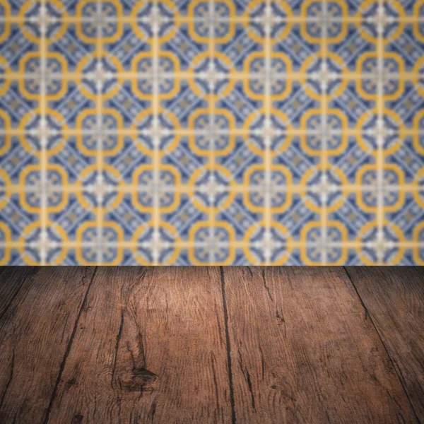 Wood table top and blur vintage ceramic tile pattern wall — Stock Photo, Image