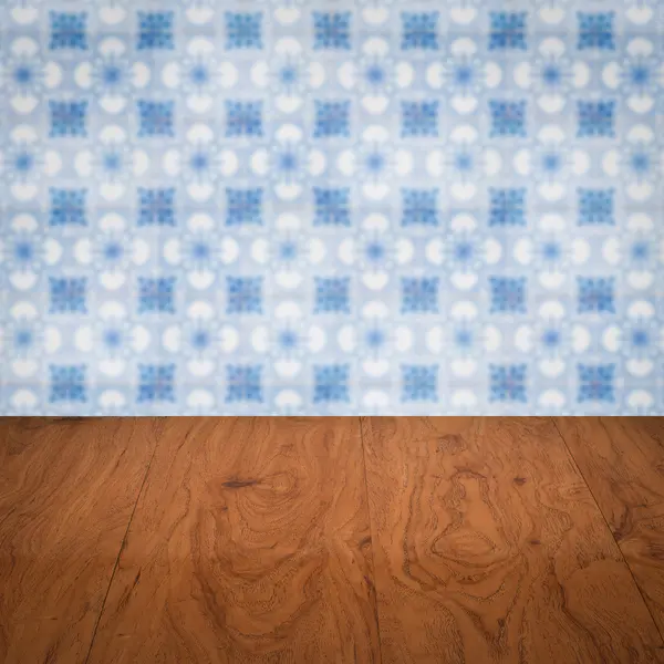 Wood table top and blur vintage ceramic tile pattern wall — Stock Photo, Image