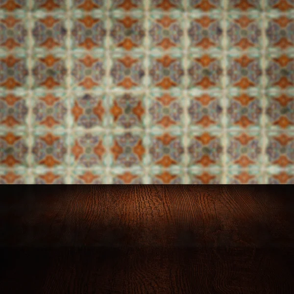 Wood table top and blur vintage ceramic tile pattern wall — Stock Photo, Image