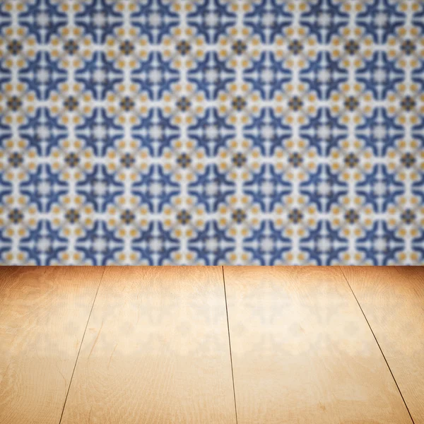 Wood table top and blur vintage ceramic tile pattern wall — Stock Photo, Image