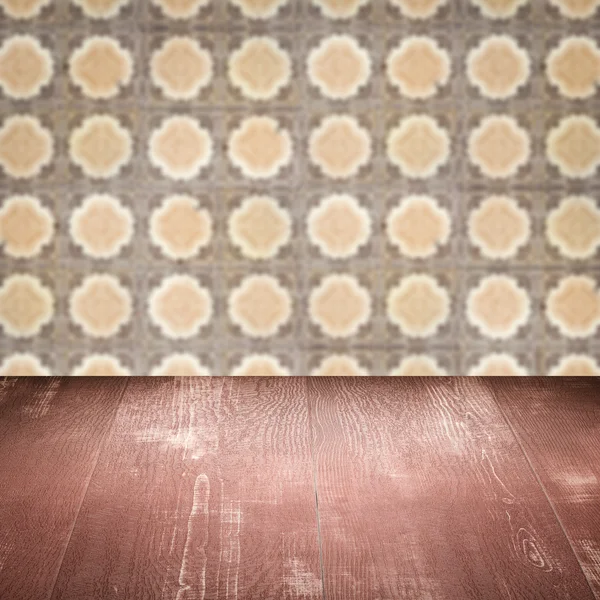 Wood table top and blur vintage ceramic tile pattern wall — Stock Photo, Image