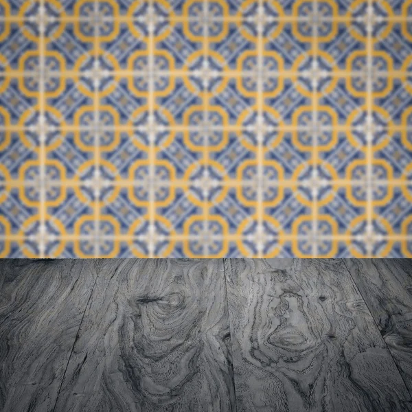 Wood table top and blur vintage ceramic tile pattern wall — Stock Photo, Image