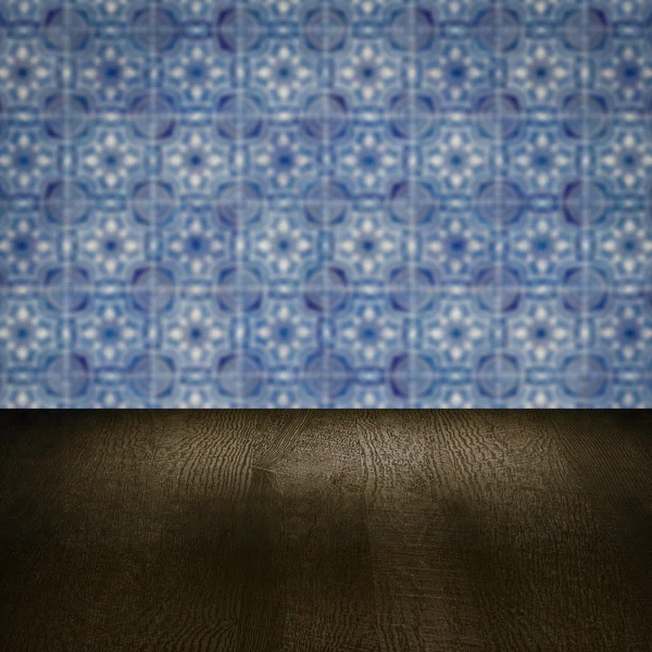 Wood table top and blur vintage ceramic tile pattern wall — Stock Photo, Image