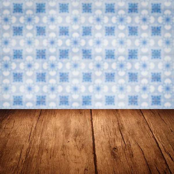 Wood table top and blur vintage ceramic tile pattern wall — Stock Photo, Image