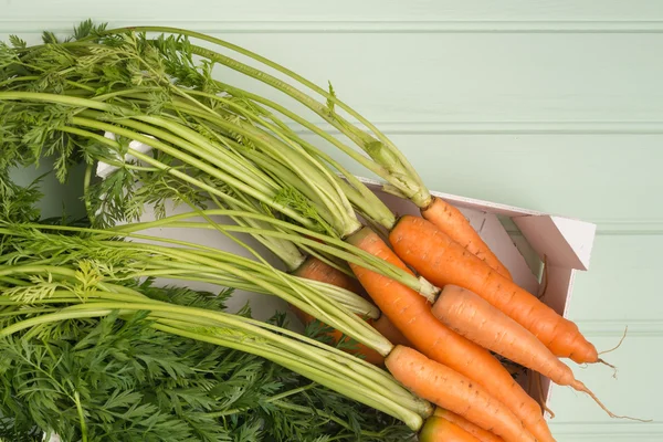 Carrots on wooden table — Stock Photo, Image