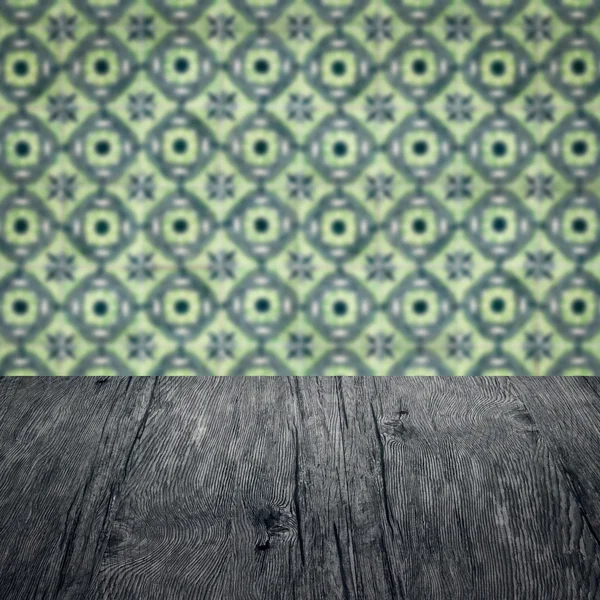 Wood table top and blur vintage ceramic tile pattern wall — Stock Photo, Image