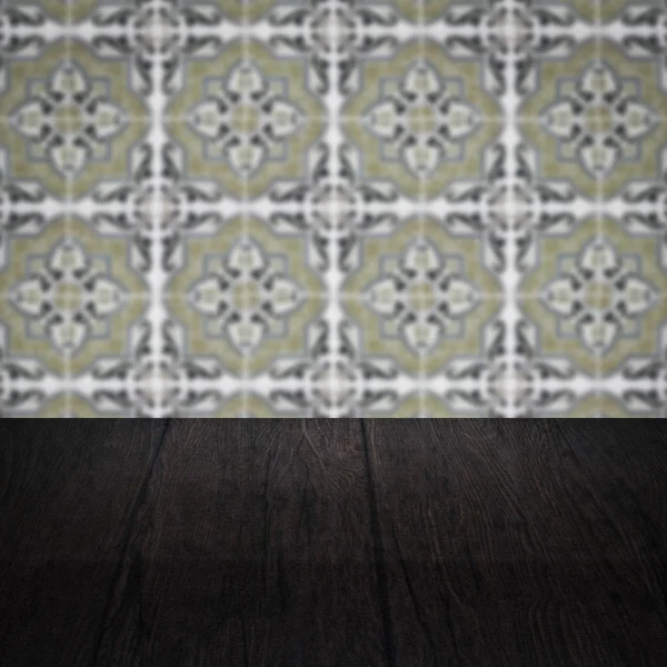 Wood table top and blur vintage ceramic tile pattern wall — Stock Photo, Image