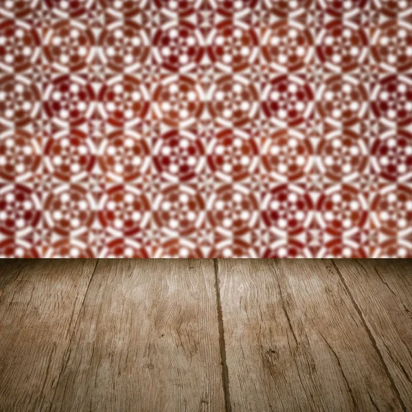 Wood table top and blur vintage ceramic tile pattern wall — Stock Photo, Image