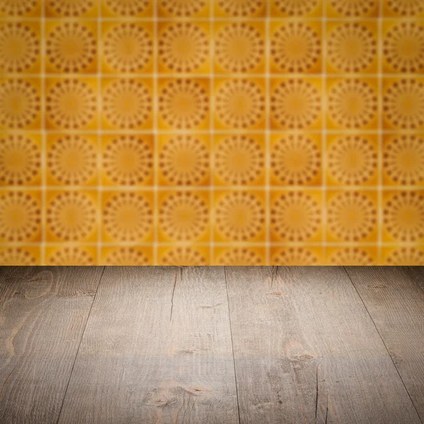 Wood table top and blur vintage ceramic tile pattern wall — Stock Photo, Image