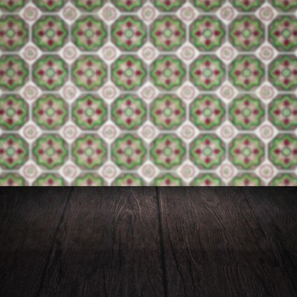 Wood table top and blur vintage ceramic tile pattern wall — Stock Photo, Image