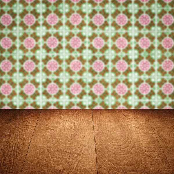 Wood table top and blur vintage ceramic tile pattern wall — Stock Photo, Image