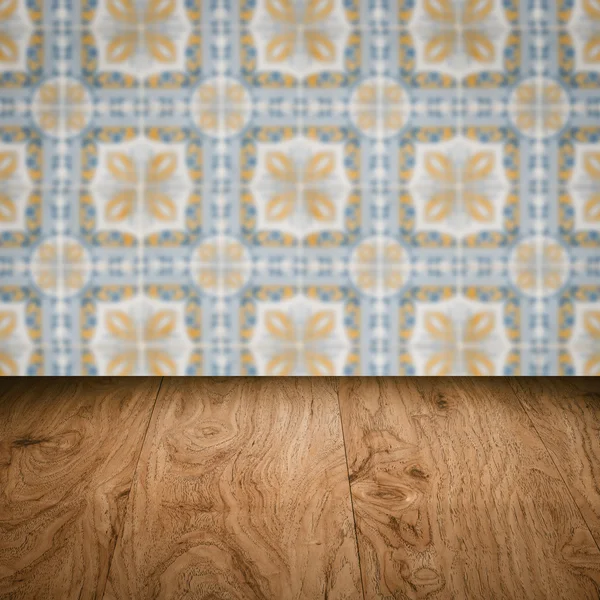 Wood table top and blur vintage ceramic tile pattern wall — Stock Photo, Image