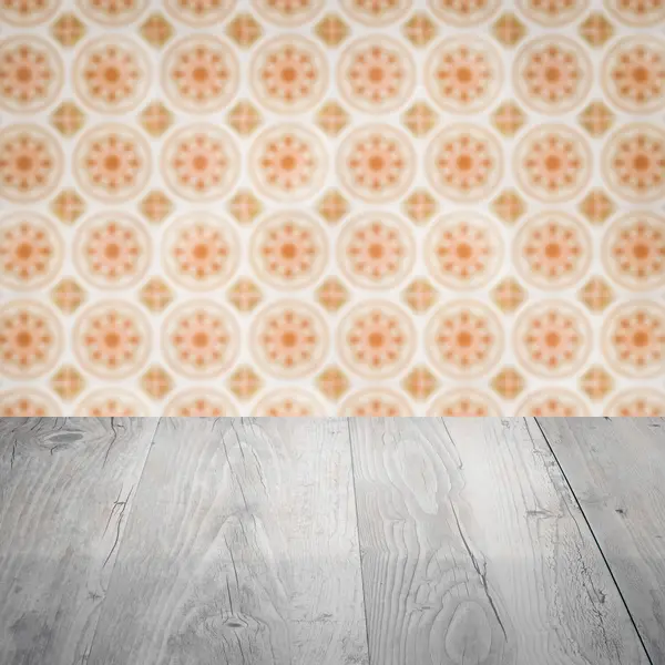 Wood table top and blur vintage ceramic tile pattern wall — Stock Photo, Image