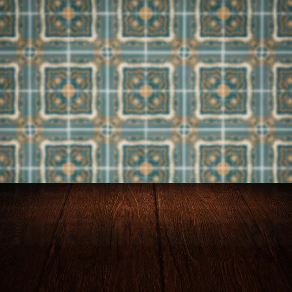 Wood table top and blur vintage ceramic tile pattern wall — Stock Photo, Image