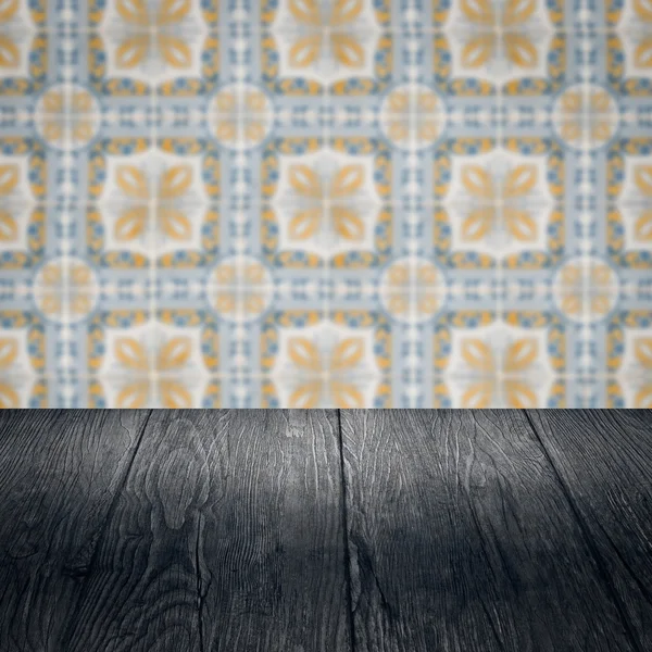 Wood table top and blur vintage ceramic tile pattern wall — Stock Photo, Image