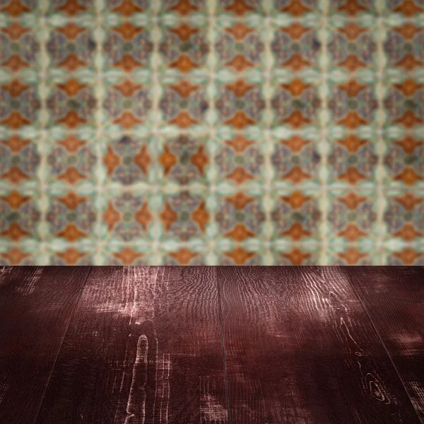 Wood table top and blur vintage ceramic tile pattern wall — Stock Photo, Image