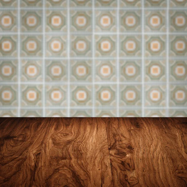 Wood table top and blur vintage ceramic tile pattern wall — Stock Photo, Image